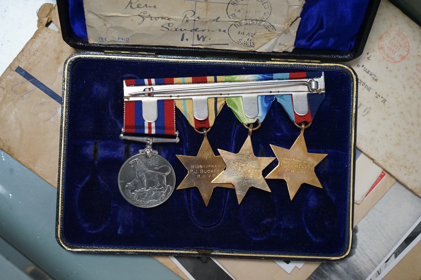 H.M.S. Hood related interest; a WWII medal group awarded to Midshipman P.J. Buckett R.N.V.R, comprising; the Atlantic Star, the Africa Star, the 1939-1945 Star and the 1939-1945 Medal, engraved with his name to the rear